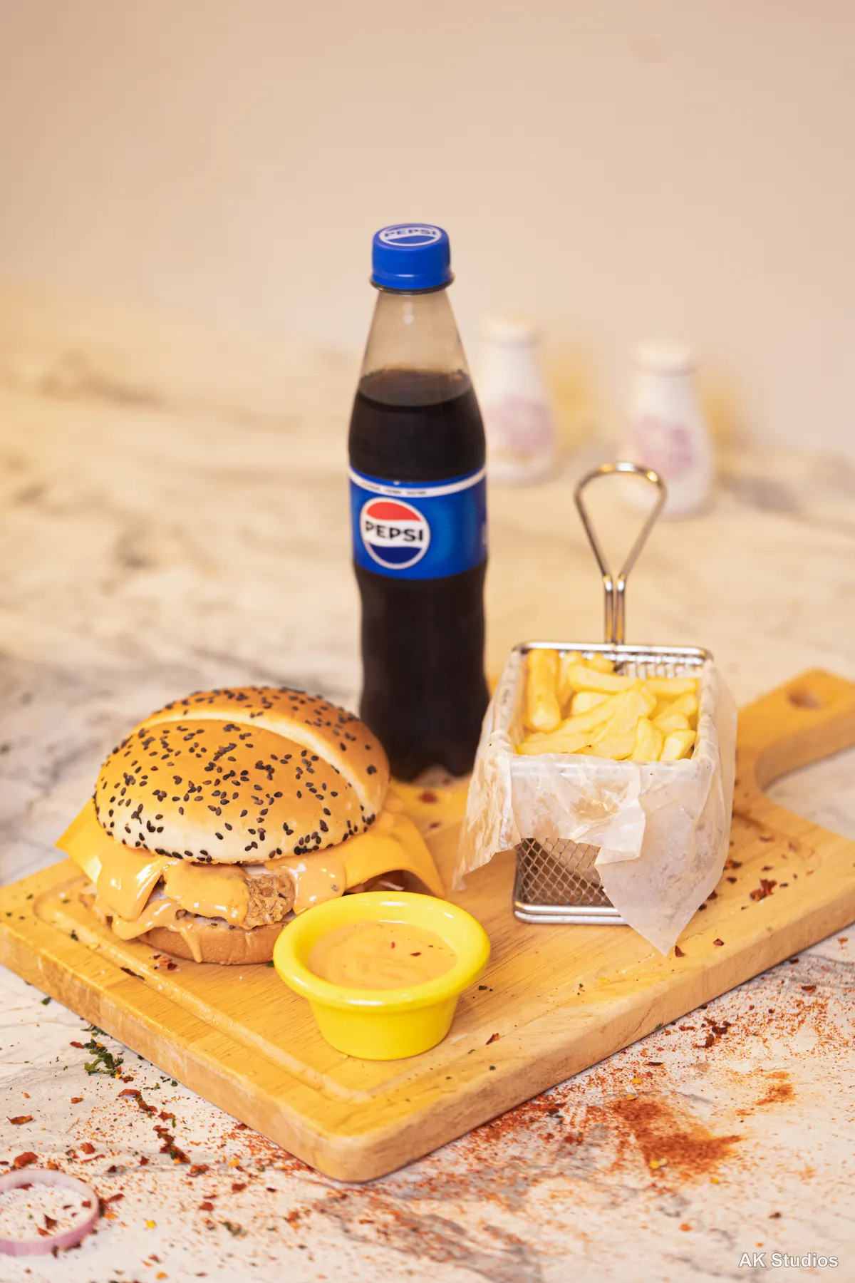 Saltish restaurant burger deal with fries and Pepsi, styled on a wooden board — food photography by AK Studios