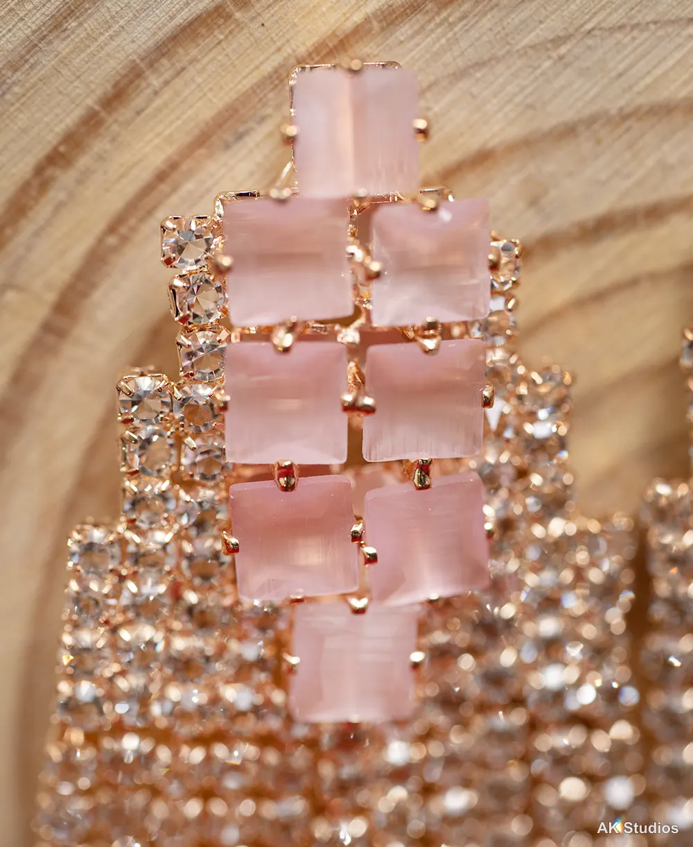 Pink enamel square stud earrings with mint stone drops, styled on wood for ecommerce product photography