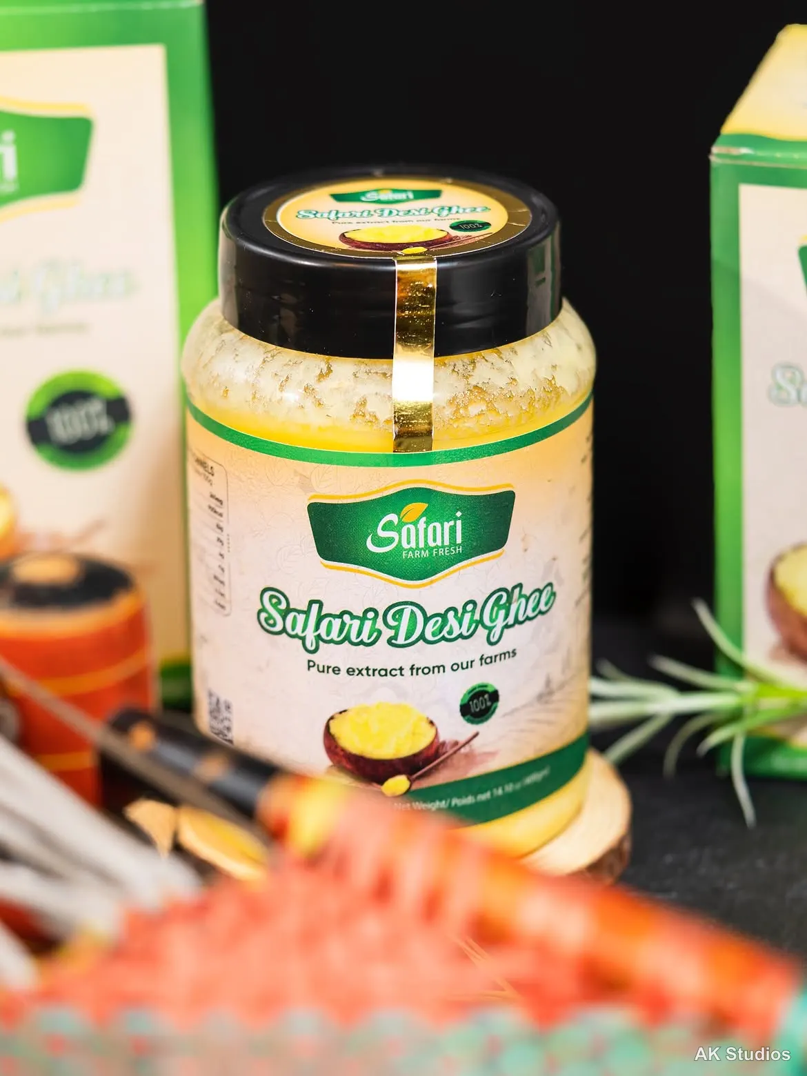 Safari Desi Ghee jar styled on a dark background with wooden spoons and rosemary — product photography by AK Studios